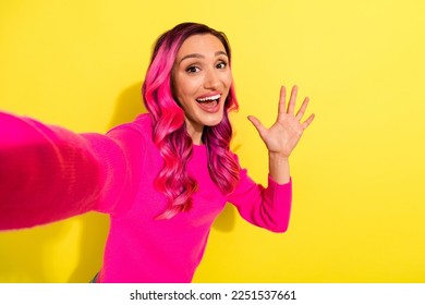 Portrait of cheerful charming lady take selfie record video arm palm waving hi isolated on yellow color background
