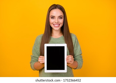 Portrait of cheerful confident cool girl hold tablet advise choose decide new gadget wear pullover isolated over vibrant color background - Powered by Shutterstock