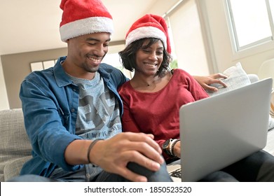 Portrait of cheerful couple with santa claus hat celebrating virtual Christmas - Powered by Shutterstock