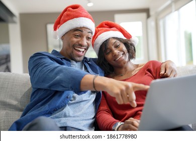 Portrait of cheerful couple with santa claus hat celebrating virtual Christmas - Powered by Shutterstock