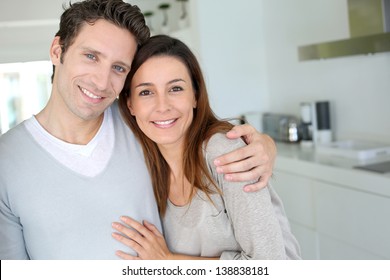 Portrait Of Cheerful Couple Standing At Home