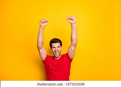 Portrait of cheerful crazy funky guy win lottery shout yeah raise fists wear casual style outfit isolated over vivid color background - Shutterstock ID 1571515558
