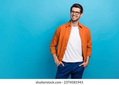 Portrait of cheerful creative minded young person toothy smile look interested empty space isolated on blue color background - Powered by Shutterstock