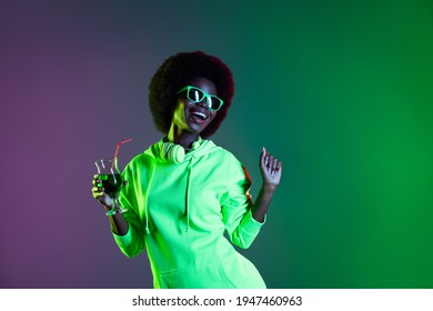 Portrait Of Cheerful Dark Skin Girl Hand Hold Drink Enjoy Glass Partying Isolated On Vivid Green Background