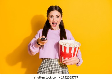 Portrait cheerful energetic girl ready watch favorite series switch remote control hold big pop corn box wear style stylish trendy plaid pullover isolated bright shine color background