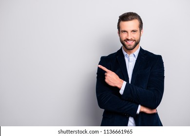 Portrait of cheerful excited joyful satisfied handsome attractive fashionable macho guy dressed in formal outfit dark velvet pointing on empty blank copyspace isolated on gray background copy-space - Powered by Shutterstock