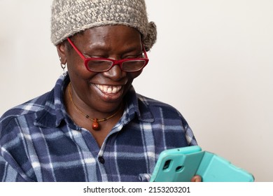 Portrait Cheerful Excited Old Black African Woman Receiving Good News With Her Smartphone. Happy Senior Lady Using Mobile Phone