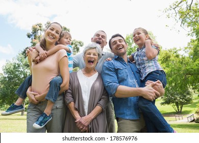 Portrait of cheerful extended family standing at the park