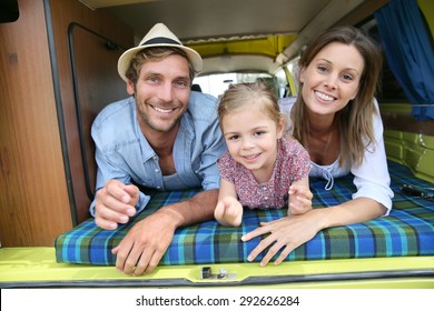 Portrait Of Cheerful Family Having Fun In Camper