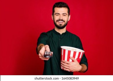 Portrait Of Cheerful Guy Have Free Time Watch Tv Switch Remote Control Hold Big Popcorn Box Enjoy Emotion Wear Good Looking Outfit Isolated Over Shine Color Background