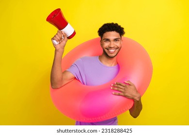Portrait of cheerful handsome person hold inflatable circle loudspeaker toa isolated on yellow color background - Shutterstock ID 2318288425