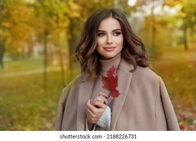 Portrait of cheerful happy woman in fall park outdoor on sunny autumn background - Shutterstock ID 2188226731