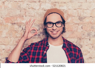 Portrait of cheerful hipster man in glasses gesturing ok - Shutterstock ID 521120821