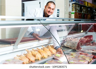 Portrait Of Cheerful Male Seller In Halal Section At Supermarket