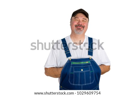 Portrait of cheerful man wearing dungarees against white background