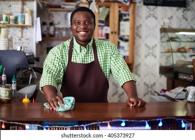 Portrait of a cheerful man working at bar counter - Powered by Shutterstock