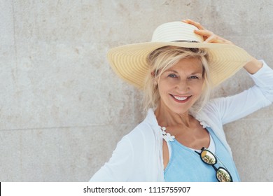 Portrait Of Cheerful Mature Blonde Woman Wearing Summer Hat