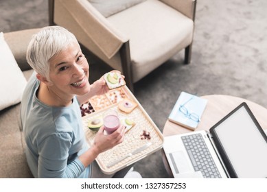 Portrait Of Cheerful Mature Woman With Beautiful Smile And Full Of Energy Eating A Healthy Nutritious Breakfast Meal, Healthy Lifestyle Concept