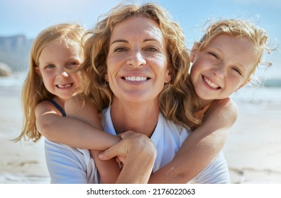 Portrait of a cheerful mature woman and little girls enjoying family time at the beach on vacation. Happy sisters smiling with adopted mother, grandma or foster parent, enjoying fresh summer air - Shutterstock ID 2176022063