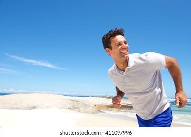 Portrait Of A Cheerful Middle Aged Man Running On The Beach 