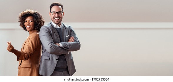 Portrait Of Cheerful Multi Ethnic Business Couple Looking At Camera