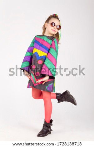 the portrait of the cheerful naughty little girl, poses in a camera