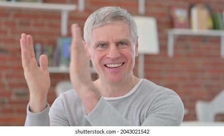 Portrait Of Cheerful Old Man Clapping