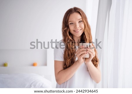 Portrait of cheerful peaceful girl toothy smile hold fresh aroma coffee mug enjoy morning calmness bedroom house inside