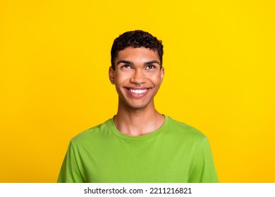Portrait of cheerful positive man beaming smile look up empty space isolated on yellow color background - Shutterstock ID 2211216821