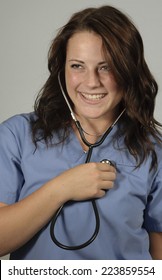 Portrait Of Cheerful Practitioner Checking Heart Beat Of Patient