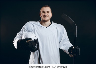 Portrait Of Cheerful Proud Caucasian Hockey Player Smiling With Teeth, Looking In Camera With Happy And Relaxed Face Expression, Posing After Victory In Hockey Match With Stick, Isolated On White