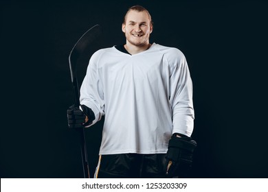 Portrait Of Cheerful Proud Caucasian Hockey Player Smiling With Teeth, Looking In Camera With Happy And Relaxed Face Expression, Posing After Victory In Hockey Match With Stick, Isolated On White