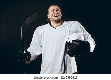 Portrait Of Cheerful Proud Caucasian Hockey Player Smiling With Teeth, Looking In Camera With Happy And Relaxed Face Expression, Posing After Victory In Hockey Match With Stick, Isolated On White