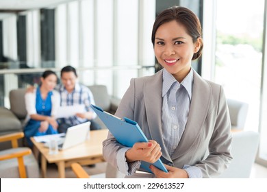 Portrait Of Cheerful Real Estate Agent With A Clipboard