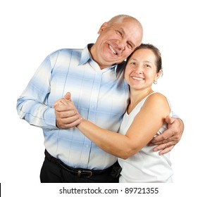 Portrait Of Cheerful Senior Couple Embracing Over Plain Background