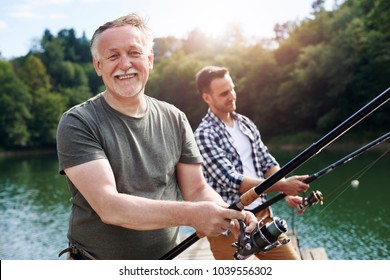 Portrait of cheerful senior man fishing 
 - Powered by Shutterstock