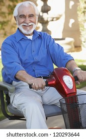 Portrait Of A Cheerful Senior Man On Electric Scooter