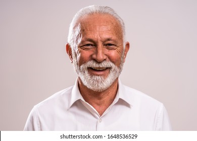 Portrait of cheerful senior man who is looking at camera and smiling. - Powered by Shutterstock