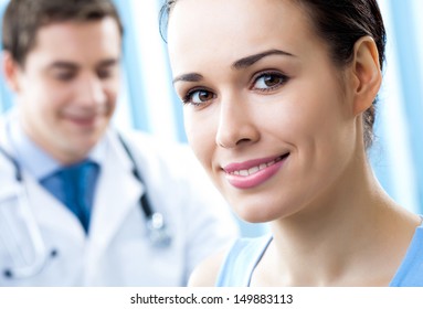 Portrait Of Cheerful Smiling Male Doctor And Female Patient