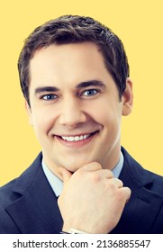 Portrait Of Cheerful Smiling Senior Businessman In Blue Suit And Tie, Over Yellow Color Background. Thinking Confident Middle Aged Business Man.