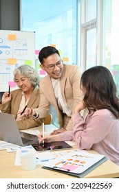 Portrait, Cheerful And Talented Asian Businessman Or Male Boss Sharing His Ideas And Discussing With A Female Employee During The Meeting.