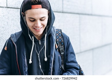 Portrait Of Cheerful Teenager Outdoors On Blurred Background, Closeup