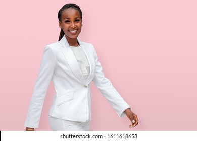 Portrait of a cheerful warm enthusiastic african american business woman CEO entrepreneur isolated on pink background, female empowerment