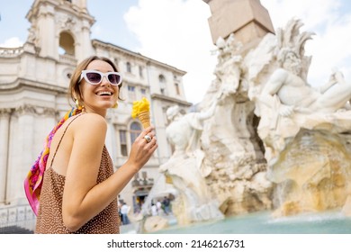 Portrait of a cheerful woman eating ice cream in cone while visiting famous Navona square near fountain in Rome. Concept of happy summer vacations, traveling famous italian landmarks - Shutterstock ID 2146216731