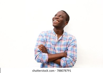 Portrait Of Cheerful Young Black Man With Arms Crossed And Looking Up On White Background