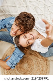 Portrait Of Cheerful Young Couple. Woman Lying On The Boyfriend's Shoulder, Both Looking Up And Smiling