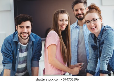 Portrait Of Cheerful Young Editors At Creative Office