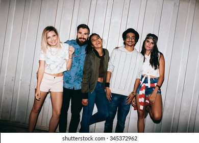 Portrait Of Cheerful Young Friends Standing Together Outdoors. Multiracial Young People Hanging Out At Night.