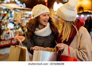 Portrait of cheerful young happy woman doing Christmas shopping. Christmas shopping people concept