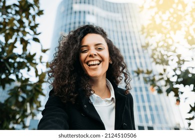 Portrait Of A Cheerful Young Latin American Woman Outdoors